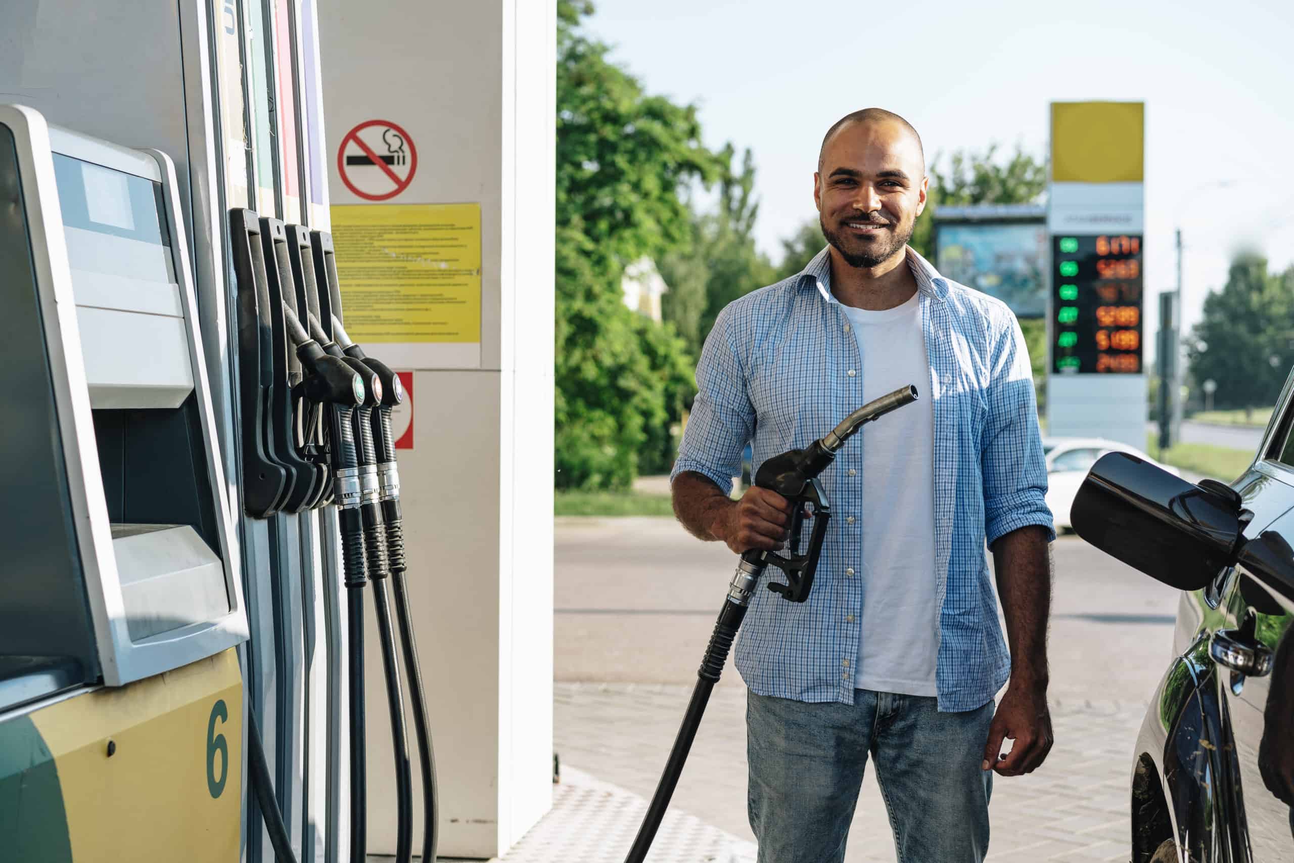 man filling fuel at gas station - excise fuel tax